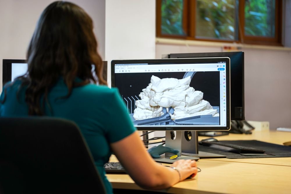 Engineer reviewing a detailed 3D CAD model on screen for digital prototyping